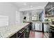 Modern kitchen with granite countertops, stainless steel appliances, and dark cabinetry at 2726 Tranquil Oak Pl, Charlotte, NC 28206
