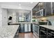 Modern kitchen featuring granite countertops, stainless steel appliances, and dark cabinetry at 2726 Tranquil Oak Pl, Charlotte, NC 28206