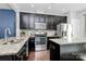 Well-equipped kitchen featuring granite countertops, stainless appliances, and dark hardwood flooring at 2726 Tranquil Oak Pl, Charlotte, NC 28206