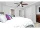 Large main bedroom with tray ceilings, a ceiling fan and ensuite bathroom entrance at 2726 Tranquil Oak Pl, Charlotte, NC 28206