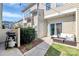 A cozy outdoor patio with patio seating, a grill and a well-maintained lawn at 2726 Tranquil Oak Pl, Charlotte, NC 28206