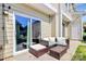 A relaxing outdoor patio with a sliding glass door and comfortable wicker furniture set at 2726 Tranquil Oak Pl, Charlotte, NC 28206
