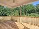 Outdoor back porch features wood flooring and a wooden railing with views of the tree-lined lot at 286 Old Pinckney Rd, York, SC 29745