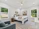 Cozy bedroom with two windows, ceiling fan, light-colored walls, and a comfortable sitting area at 286 Old Pinckney Rd, York, SC 29745