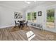 Cozy dining area with natural light, wood floors, a stylish bench, and a glass patio door at 286 Old Pinckney Rd, York, SC 29745