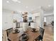 Modern kitchen with white cabinets, stainless appliances, granite countertops, and wood dining table at 286 Old Pinckney Rd, York, SC 29745