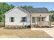 Charming single-story home with a covered front porch, neutral siding and a well-manicured lawn at 286 Old Pinckney Rd, York, SC 29745