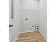 Laundry room with white walls, light wood floors, and a wire storage shelf at 286 Old Pinckney Rd, York, SC 29745