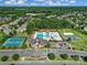 Aerial view of a community clubhouse and recreation area, featuring pools, tennis courts, and playgrounds at 2909 Julian Glen Cir, Waxhaw, NC 28173