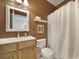 Cozy brown bathroom featuring a wood vanity, square framed mirror, and shower/tub combo with white curtain at 2909 Julian Glen Cir, Waxhaw, NC 28173