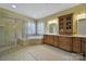 Spacious bathroom showcasing a glass-enclosed shower, soaking tub, dual vanity, and plenty of natural light at 2909 Julian Glen Cir, Waxhaw, NC 28173