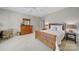 Spacious bedroom with natural light, wood furniture, and neutral carpeting at 2909 Julian Glen Cir, Waxhaw, NC 28173