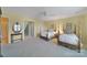 Bright bedroom with matching twin beds, light yellow walls and neutral carpet at 2909 Julian Glen Cir, Waxhaw, NC 28173