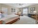 Bright bedroom featuring a ceiling fan, patterned curtains, and a wood-frame bed at 2909 Julian Glen Cir, Waxhaw, NC 28173