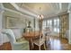 Formal dining room with a coffered ceiling, hardwood floors, and elegant chandelier at 2909 Julian Glen Cir, Waxhaw, NC 28173