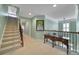 Well-lit foyer features carpeted stairs, neutral walls, wood railing, and decorative artwork and furniture at 2909 Julian Glen Cir, Waxhaw, NC 28173
