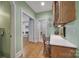 Hallway with hardwood floors, desk space, and views into the living areas at 2909 Julian Glen Cir, Waxhaw, NC 28173