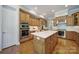 Spacious kitchen with stainless steel appliances, a large island, and wooden cabinetry at 2909 Julian Glen Cir, Waxhaw, NC 28173