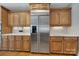 Kitchen featuring stainless steel refrigerator, wooden cabinetry, and white countertops at 2909 Julian Glen Cir, Waxhaw, NC 28173