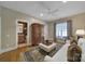 Inviting living room features hardwood floors, neutral paint, natural light, and access to an ensuite bathroom at 2909 Julian Glen Cir, Waxhaw, NC 28173