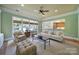 Bright living room featuring a ceiling fan, cozy seating arrangement, and large windows at 2909 Julian Glen Cir, Waxhaw, NC 28173