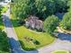 Aerial view of brick home with landscaped front yard and mature trees in a desirable neighborhood at 3401 Cresta Ct, Charlotte, NC 28269
