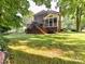 Expansive backyard featuring a deck, screened porch, and lush greenery, providing ample space for outdoor activities at 3401 Cresta Ct, Charlotte, NC 28269