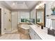 Bright bathroom showcasing a soaking tub, separate shower, and double sink vanity at 3401 Cresta Ct, Charlotte, NC 28269