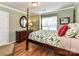 Bedroom boasts a four-poster bed, vibrant green walls, and warm hardwood flooring at 3401 Cresta Ct, Charlotte, NC 28269
