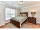 Bedroom with hardwood floors, a wood bed frame, and a large window with natural light at 3401 Cresta Ct, Charlotte, NC 28269