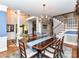 Elegant dining room featuring hardwood floors, chandelier, and staircase is a perfect space to entertain at 3401 Cresta Ct, Charlotte, NC 28269