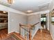 Second floor hallway with wood floors and access to bedrooms at 3401 Cresta Ct, Charlotte, NC 28269