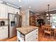 Spacious kitchen with a central island, stainless steel refrigerator, and view to the living room at 3401 Cresta Ct, Charlotte, NC 28269
