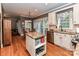 Bright kitchen with stainless steel appliances and a granite island, with view of dining and living areas at 3401 Cresta Ct, Charlotte, NC 28269