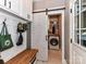 Well-organized laundry room with white cabinets, wood bench, and sliding barn door for a modern and functional space at 3401 Cresta Ct, Charlotte, NC 28269