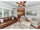 Inviting living room with view to the kitchen, featuring a leather sofa and natural light at 3401 Cresta Ct, Charlotte, NC 28269