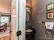 Stylish powder room featuring decorative mirror, sink, and fixtures adds a touch of elegance at 3401 Cresta Ct, Charlotte, NC 28269