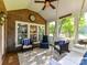 Charming screened-in porch featuring cozy seating, decorative signs, and ample natural light streaming through the windows at 3401 Cresta Ct, Charlotte, NC 28269