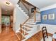 Elegant staircase with white railings and wood treads, complemented by blue accent wall at 3401 Cresta Ct, Charlotte, NC 28269