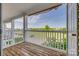 Private balcony features wood decking, white railings, and a serene view of a green landscape at 3849 Carl Parmer Dr, Harrisburg, NC 28075