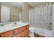 Cozy bathroom featuring wood-look vinyl flooring and a shower-tub combo with patterned shower curtain at 3849 Carl Parmer Dr, Harrisburg, NC 28075