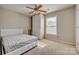 Neutral bedroom featuring plush carpet, a ceiling fan, a queen bed and a bright window at 3849 Carl Parmer Dr, Harrisburg, NC 28075