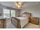 Bedroom with ceiling fan, large window with blinds, and luxurious bed at 3849 Carl Parmer Dr, Harrisburg, NC 28075