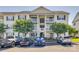 Attractive apartment building with light-yellow siding, blue shutters, and well-maintained landscaping at 3849 Carl Parmer Dr, Harrisburg, NC 28075