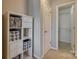 Hallway with shelving unit, and walk in closet with installed closet organizer at 3849 Carl Parmer Dr, Harrisburg, NC 28075