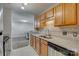 Kitchen area featuring wooden cabinetry, stainless steel dishwasher, and granite countertops at 3849 Carl Parmer Dr, Harrisburg, NC 28075