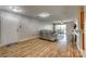 Spacious living room featuring wood floors, modern lighting, and a glass sliding door to the balcony at 3849 Carl Parmer Dr, Harrisburg, NC 28075