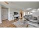 Living room leading to the kitchen with comfortable seating, a mirrored table, and modern decor at 3849 Carl Parmer Dr, Harrisburg, NC 28075