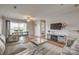 Bright living area with wood floors, a mirrored coffee table and entertainment center, plus balcony access at 3849 Carl Parmer Dr, Harrisburg, NC 28075