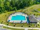 Aerial shot of neighborhood pool surrounded by chairs and umbrellas and featuring a nearby walking trail at 3849 Carl Parmer Dr, Harrisburg, NC 28075